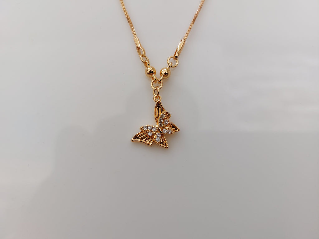 A gold butterfly pendant necklace with small clear rhinestones on its wings, shown on a plain light gray background.
